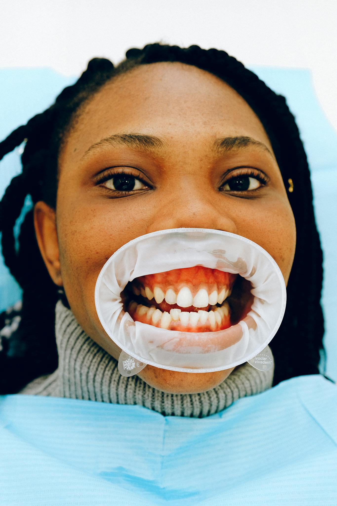 Female ethnic patient with open mouth in dental clinic